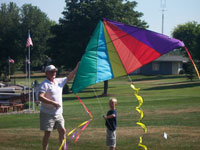 New Roads back pain free grandpa and grandson playing with a kite